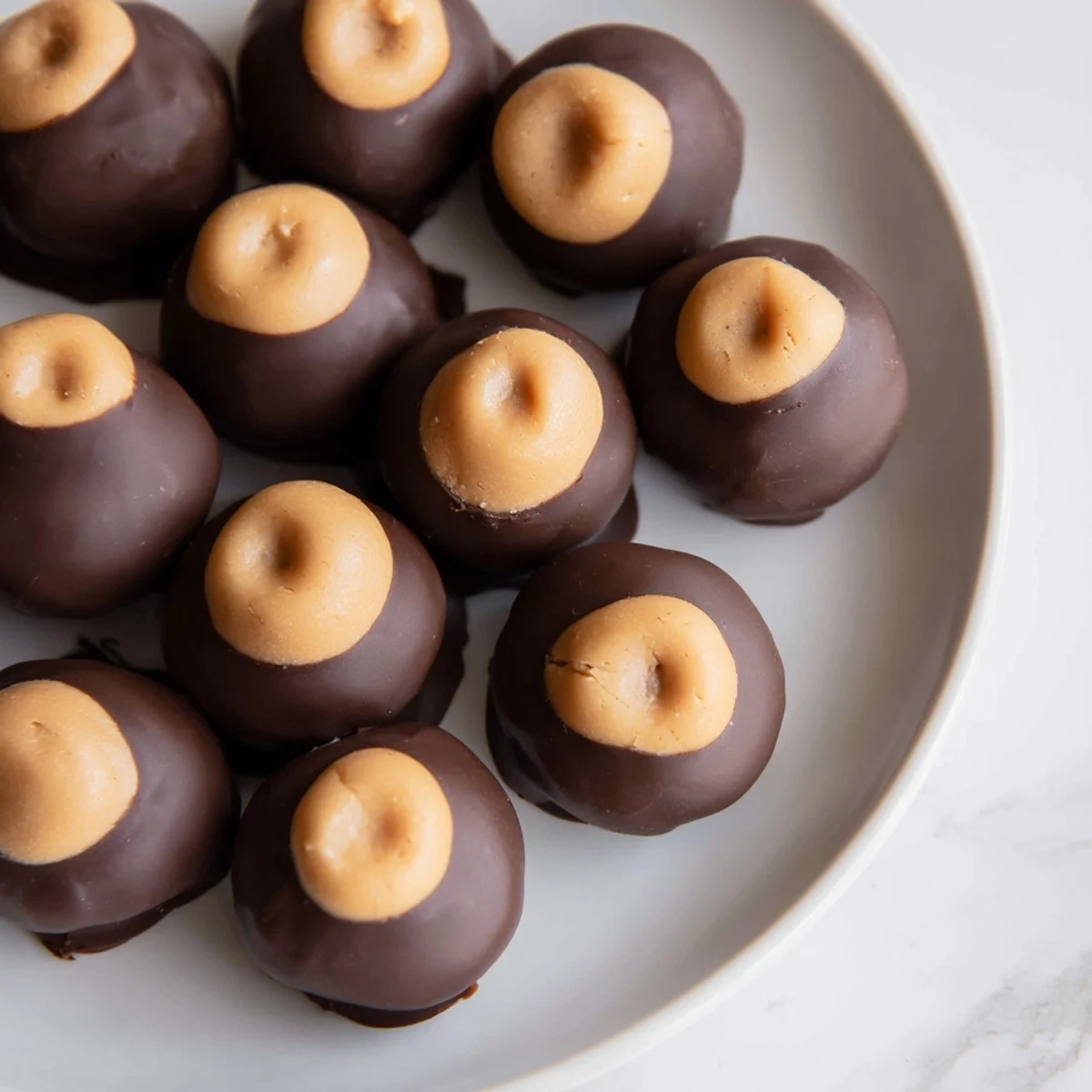 Creamy Peanut Butter Balls coated in rich, dark chocolate, a delicious no-bake dessert.