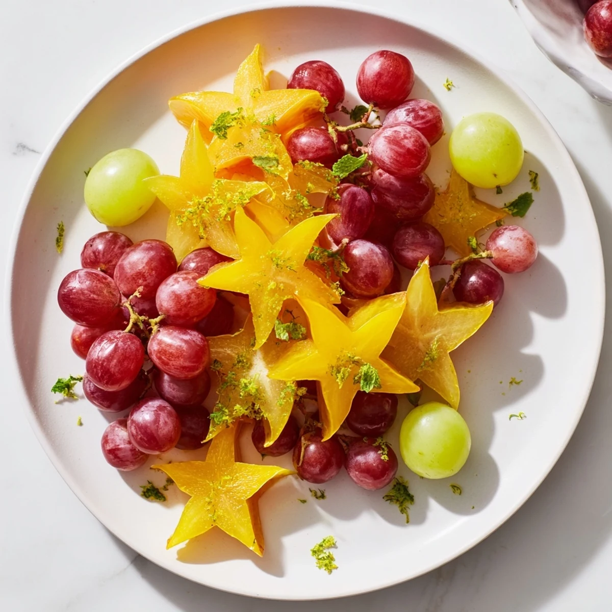 Bright, colorful starfruit slices and grapes create a refreshing brunch fruit garnish, ready to enjoy.