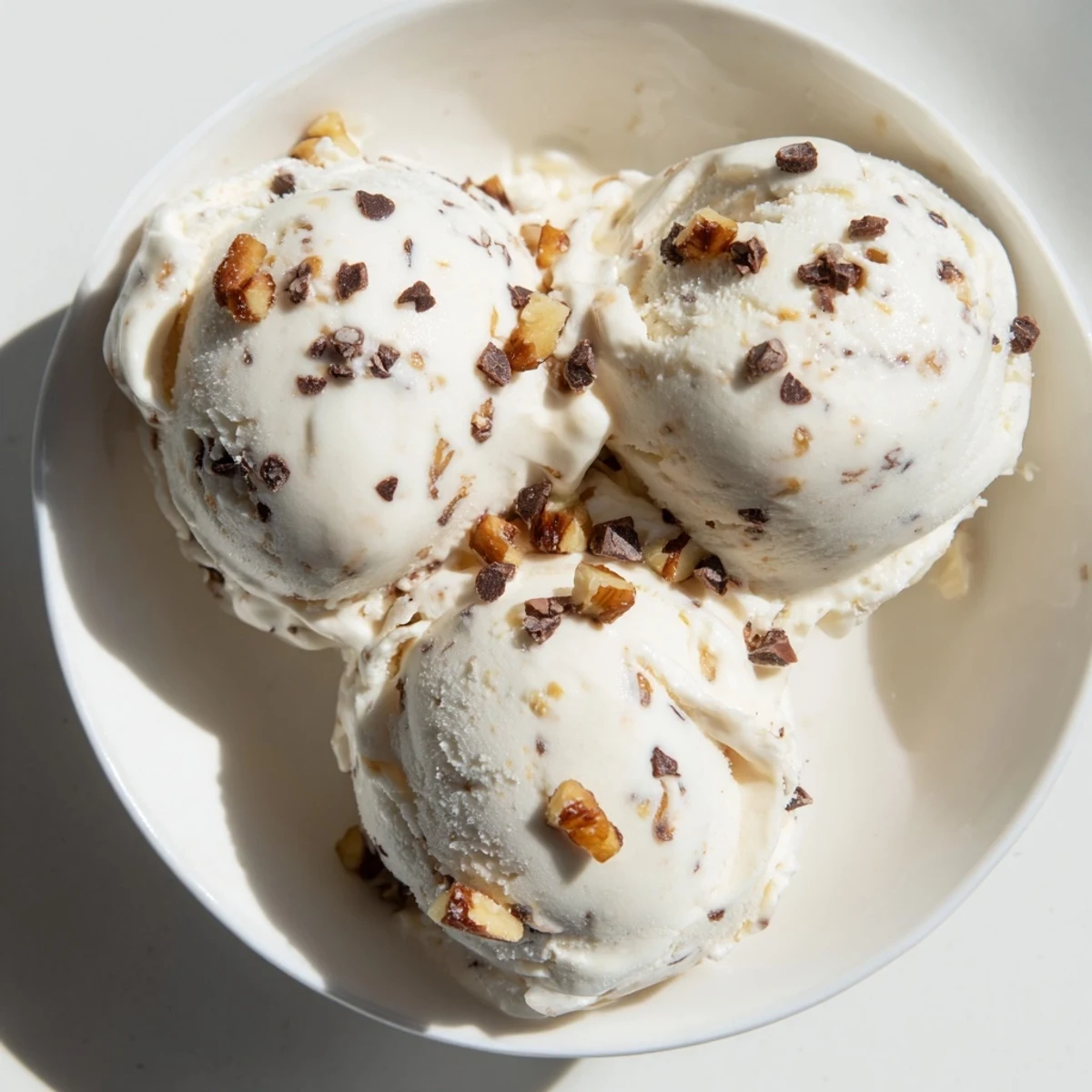 A bowl of fresh Cottage Cheese Ice Cream, a protein-rich treat with chocolate chips.