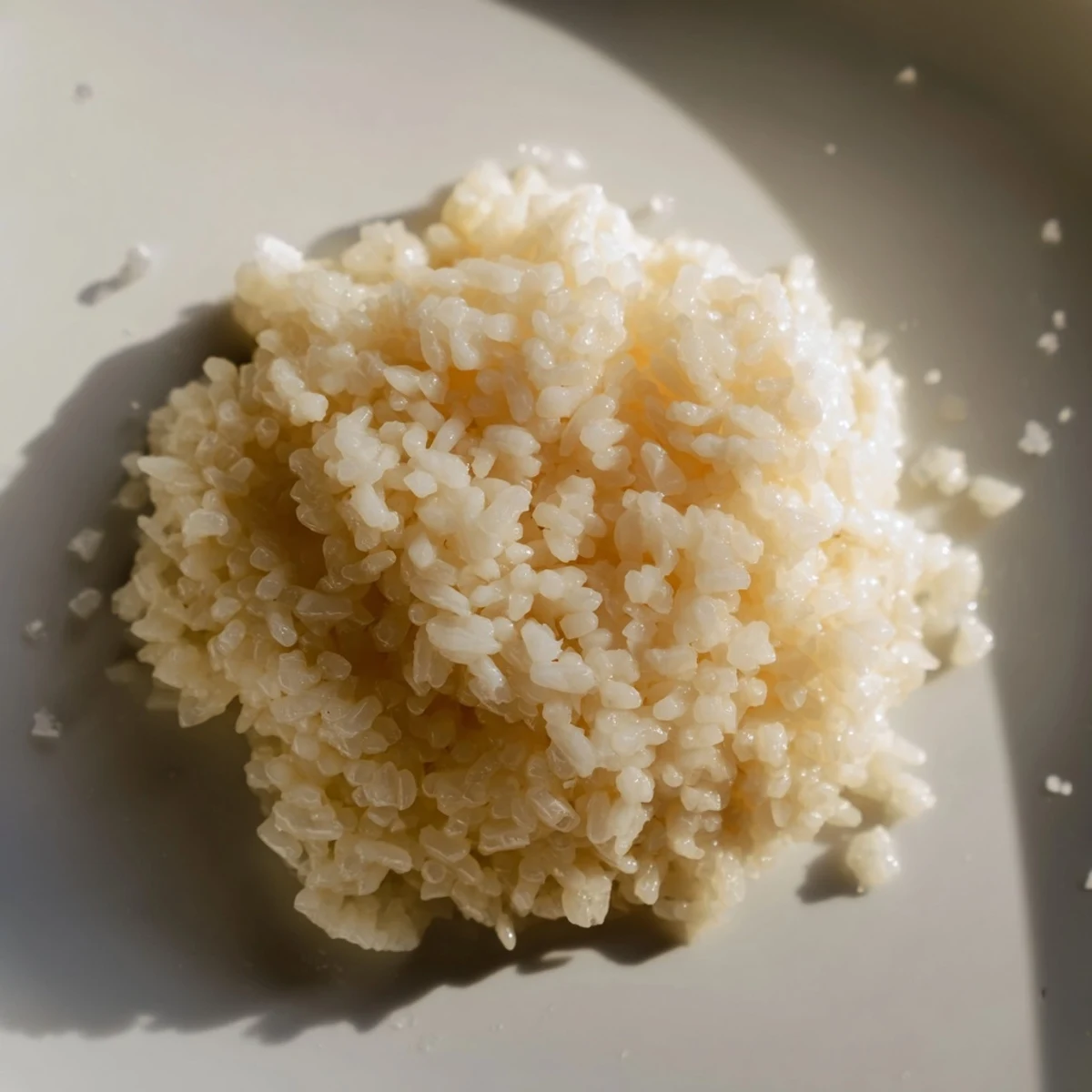 Fluffy, creamy Coconut Jasmine Rice, ready to serve with vibrant green vegetables beside.