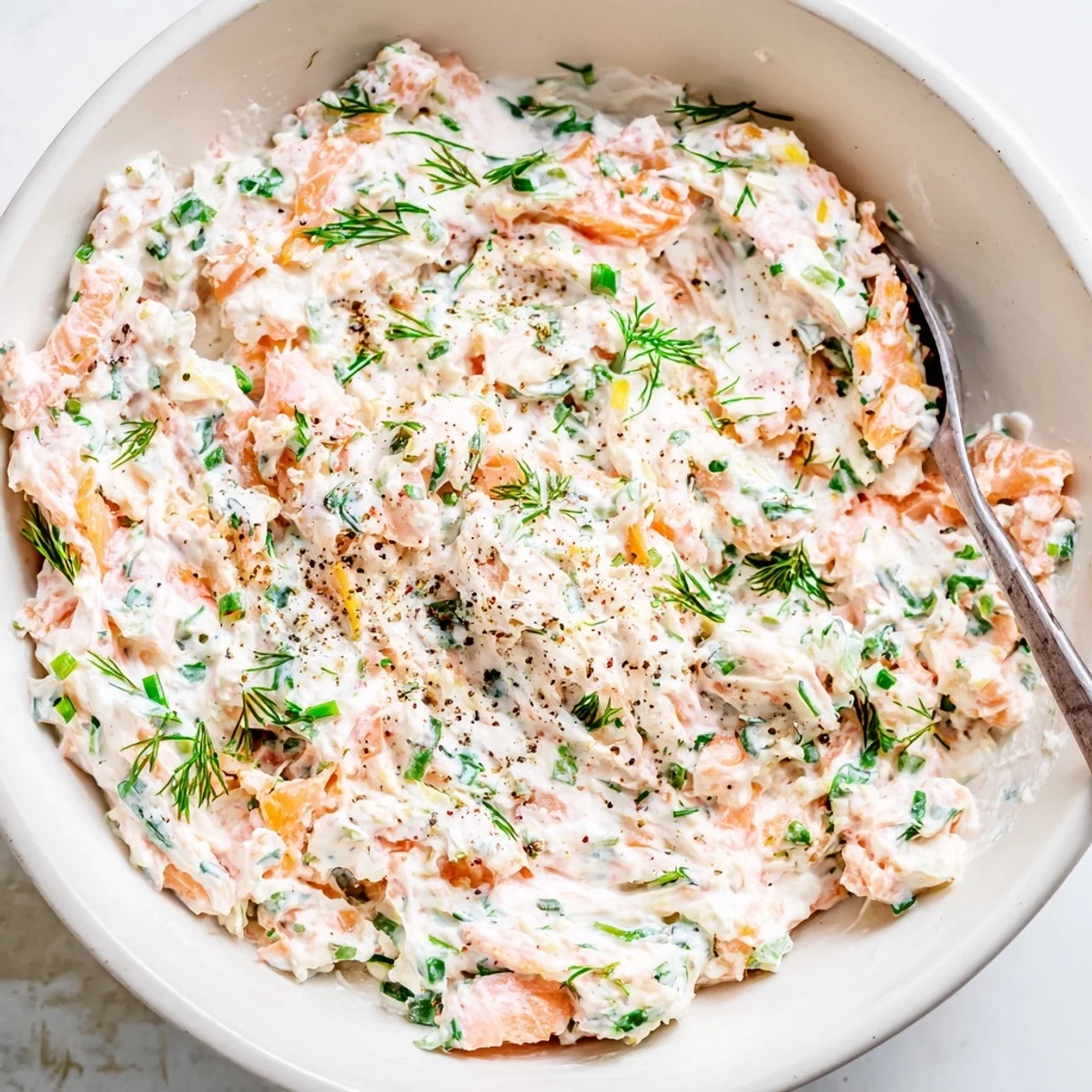 Smooth smoked salmon dip with bright lemon zest ready for a party platter or appetizer spread.