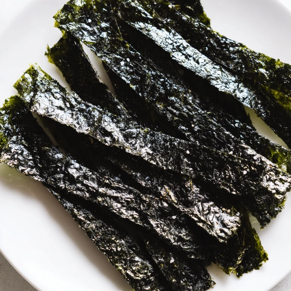 Roasted seaweed chips served in a bowl, garnished with sesame seeds for extra crunch.