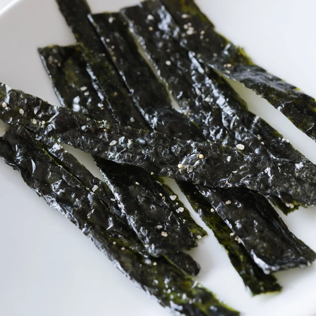 Crispy nori strips baked to perfection, showing off a rich dark green color.  