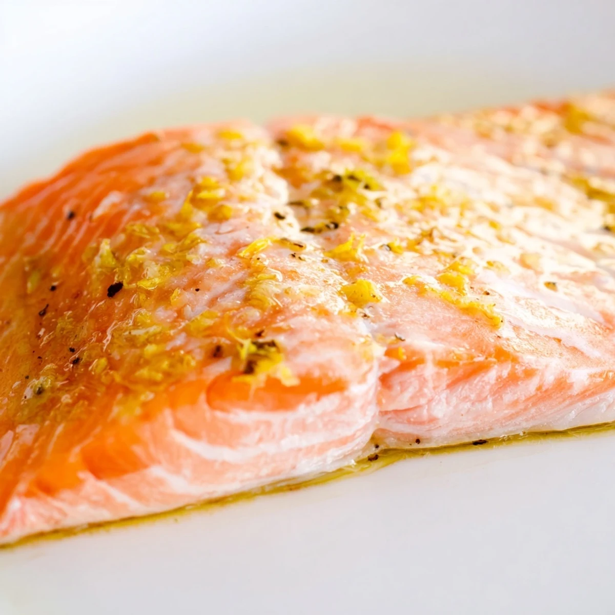 Golden salmon fillet complements a colorful Lemon Herb Salmon Salad with cherry tomatoes and red onion, ready to serve.