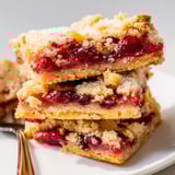 Buttery Easy Cranberry Orange Crumble Bars with juicy filling, showcasing the cookie crumble texture.