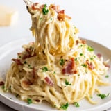 Delectable Carbonara Ramen Fusion, ready in minutes, featuring cheesy noodles and crispy bacon bits.