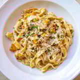 Golden-hued Healthy Creamy Pumpkin Sage Holiday Pasta with creamy sauce, a beautiful and comforting dish.