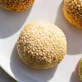 Freshly baked Palestinian Kahk, a Middle Eastern dessert, with visible sesame seed coating and soft texture.