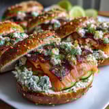 Spring Brunch Smoked Salmon Bagel Board with Cream Cheese: A colorful spread of smoked salmon, assorted bagels, fresh vegetables, and whipped herb cream cheese for an elegant brunch.