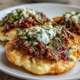 Delectable cloud bread tacos bursting with seasoned taco meat and vibrant salsa.