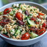 Bright Summer Orzo Salad brimming with feta, lemon, and fresh vegetables.
