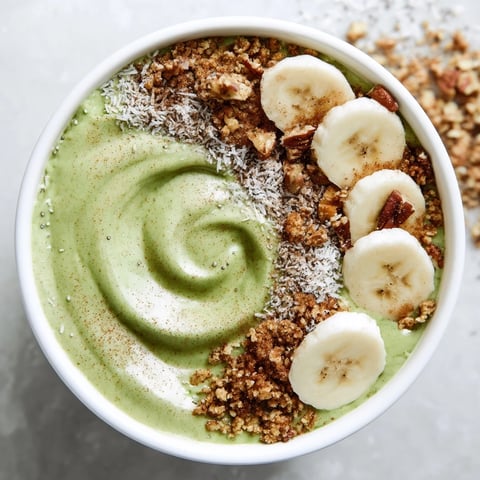 Creamy High-Protein Eggnog Matcha Overnight Oats are served cold with banana and coconut.