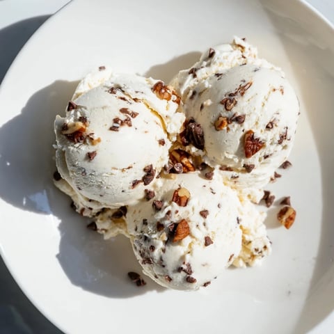 Smooth and creamy Cottage Cheese Ice Cream, swirled with fresh berries, ready to scoop.