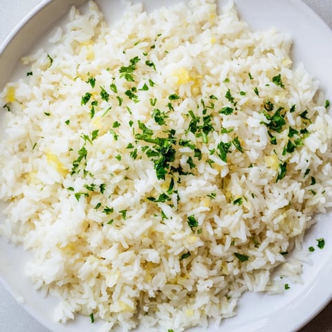 Golden, fluffy garlic butter rice, a side dish simmered to tender perfection with subtle garlic notes.