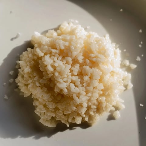 Fluffy, creamy Coconut Jasmine Rice, ready to serve with vibrant green vegetables beside.