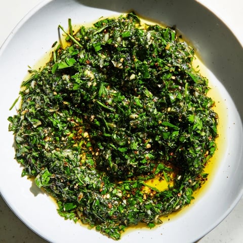 Bright, herby Moroccan Chermoula Marinade, ready to coat fresh fish for a flavorful, aromatic meal.