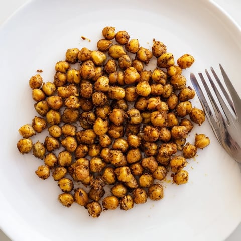 Golden, crispy chickpeas roasted with smoky paprika and cumin, spiced to perfection for a savory snack.