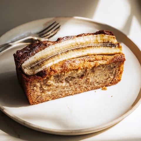 Steaming, golden-brown 5-Ingredient Banana Bread loaf, ready and delicious, for breakfast or a snack.