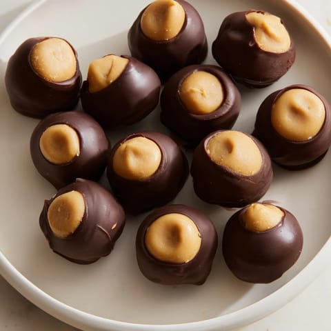 These homemade Peanut Butter Balls, dipped in glossy chocolate, offer a perfect sweet treat.