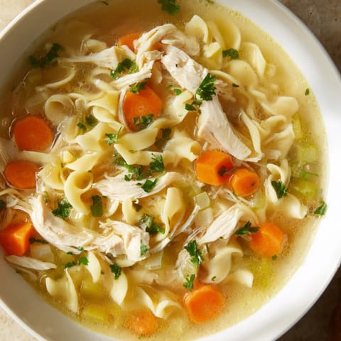 Homemade Classic Chicken Noodle Soup brimming with noodles, perfect for a cozy, comforting meal.
