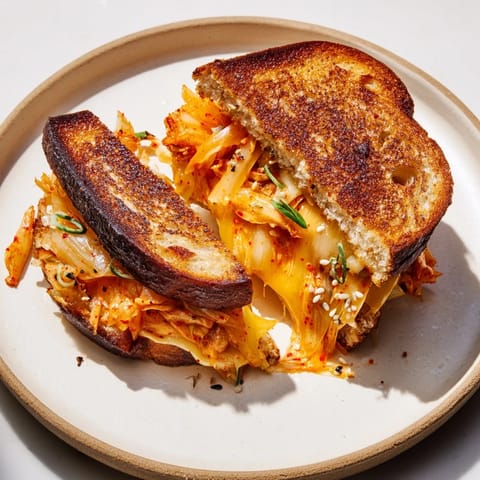 Melted cheddar cheese and spicy kimchi combine in this amazing Skillet Kimchi & Cheddar creation.