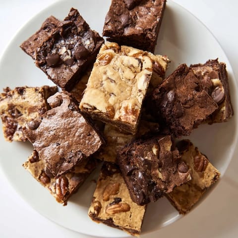 Indulge in a visual of a platter of freshly baked brownie and blondie squares, an American treat.