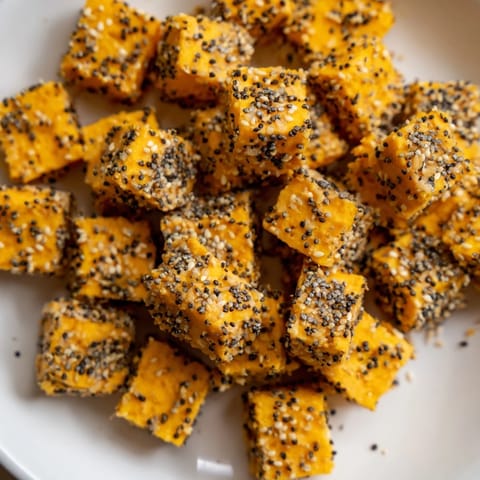 Golden, seasoned everything bagel seasoning cheese cubes ready to serve as a tasty, easy appetizer.