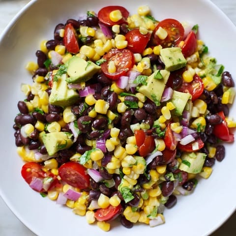 Close-up of freshly made Southwestern Black Bean and Corn Salad bursting with summer flavors and textures.