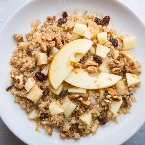 A close-up of a warm Apple Cinnamon Quinoa Bowl, inviting with cinnamon and sweet apple pieces.