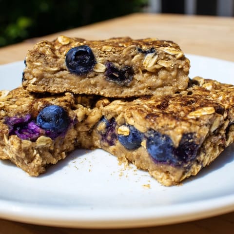 Golden Blueberry Banana Oatmeal Protein Bars, filled with juicy blueberries, ready to eat and enjoy for breakfast.