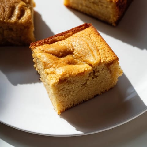 A close-up of a delectable slice of Peanut Butter Mochi Cake, boasting a rich, nutty flavor.