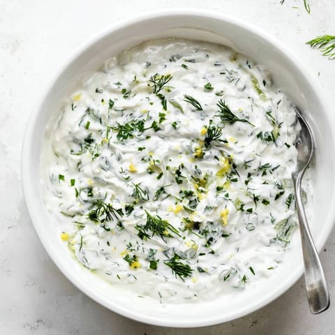 This tangy Greek Yogurt Herb Dip is swirled with lemon and fresh herbs, perfect for a healthy appetizer platter.