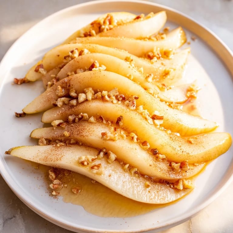 Close-up of sweet, juicy pear slices topped with honey, suitable for any time of day.