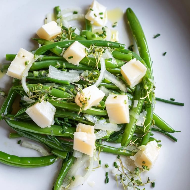 A beautiful The English Ivy salad, showcasing blanched vegetables with sharp white cheddar and delicate chives.