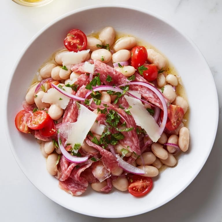 A refreshing close-up of Italian Antipasto Bean Salad, featuring cannellini beans and a zesty Italian dressing.