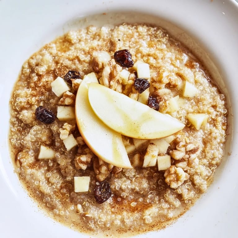 Delicious Apple Cinnamon Quinoa Bowl, a healthy vegetarian breakfast topped with fresh apples and syrup.