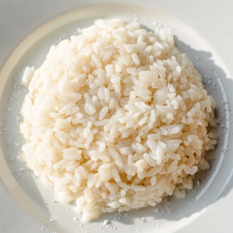 Steaming Coconut Jasmine Rice, offering a comforting aroma to complement a savory curry.