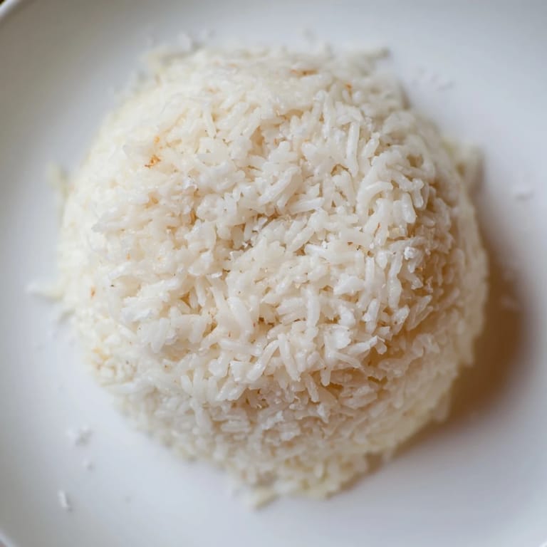 A bowl of golden Coconut Jasmine Rice, perfect as a side dish, ready for any meal.