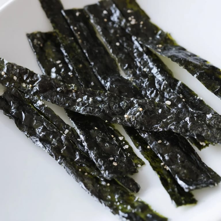 Crispy nori strips baked to perfection, showing off a rich dark green color.  