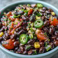 Zesty 3-Ingredient Cowboy Caviar Dip with black beans, corn, and pico de gallo in a colorful bowl.